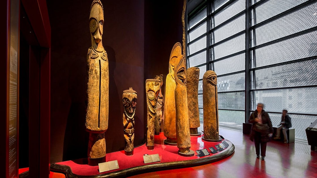 Quai Branly Museum interior with tribal sculptures, Paris.