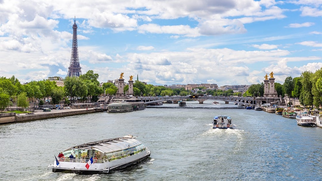 Seine River cruise with Eiffel Tower and Pont Alexandre III in Paris.