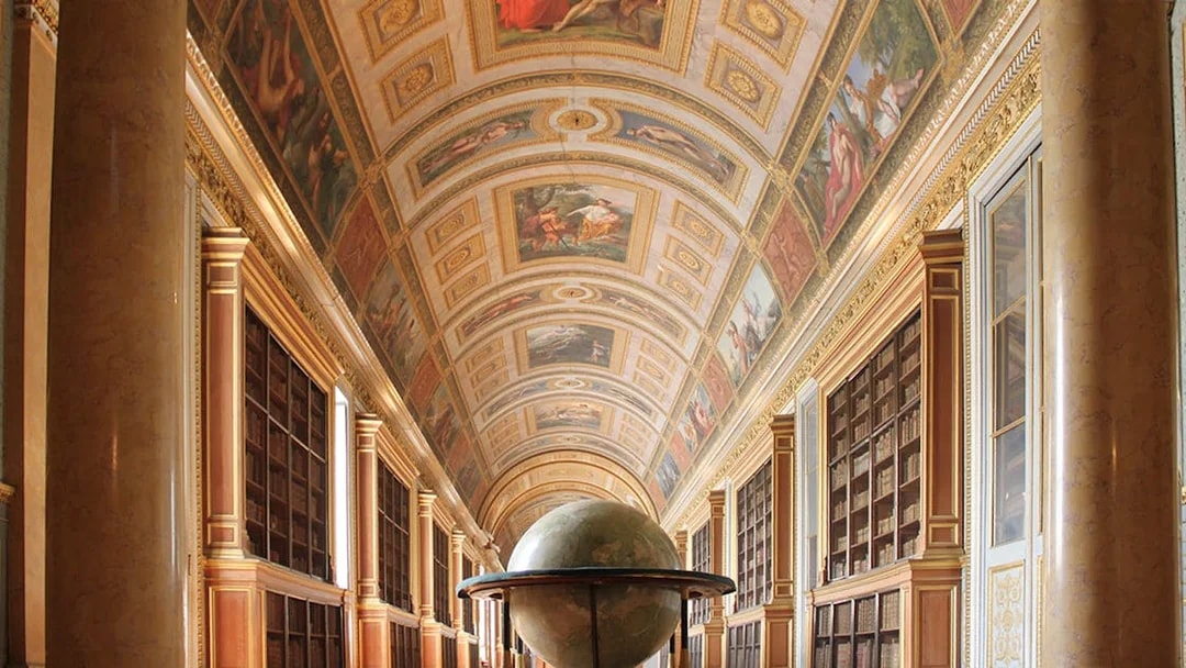 Château de Fontainebleau interior with ornate ceiling and large globe.