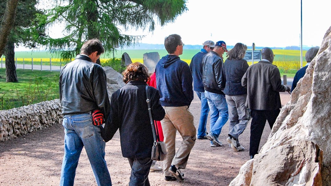 Group walking through Somme battlefields on a day trip from Paris.