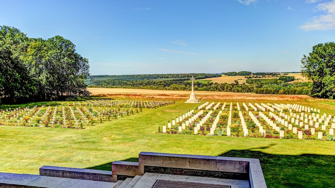 Somme battlefield cemetery with rows of white crosses and a memorial, France.