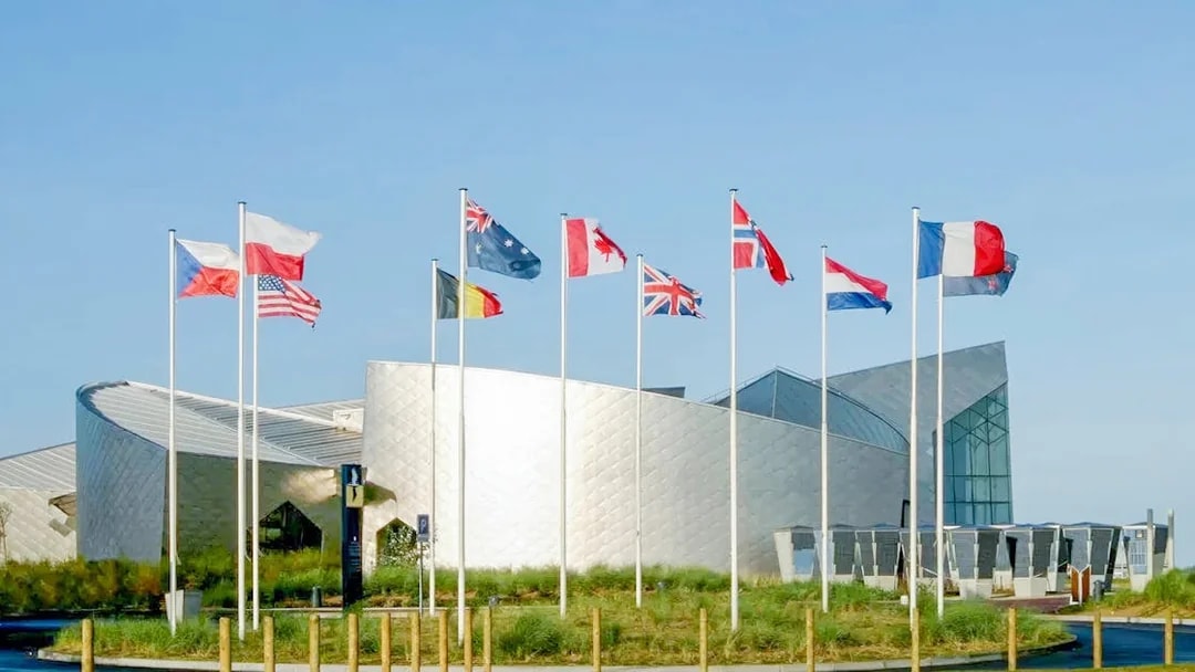 Flags outside the Juno Beach Centre in Normandy, France, part of the D-Day tour from Paris.