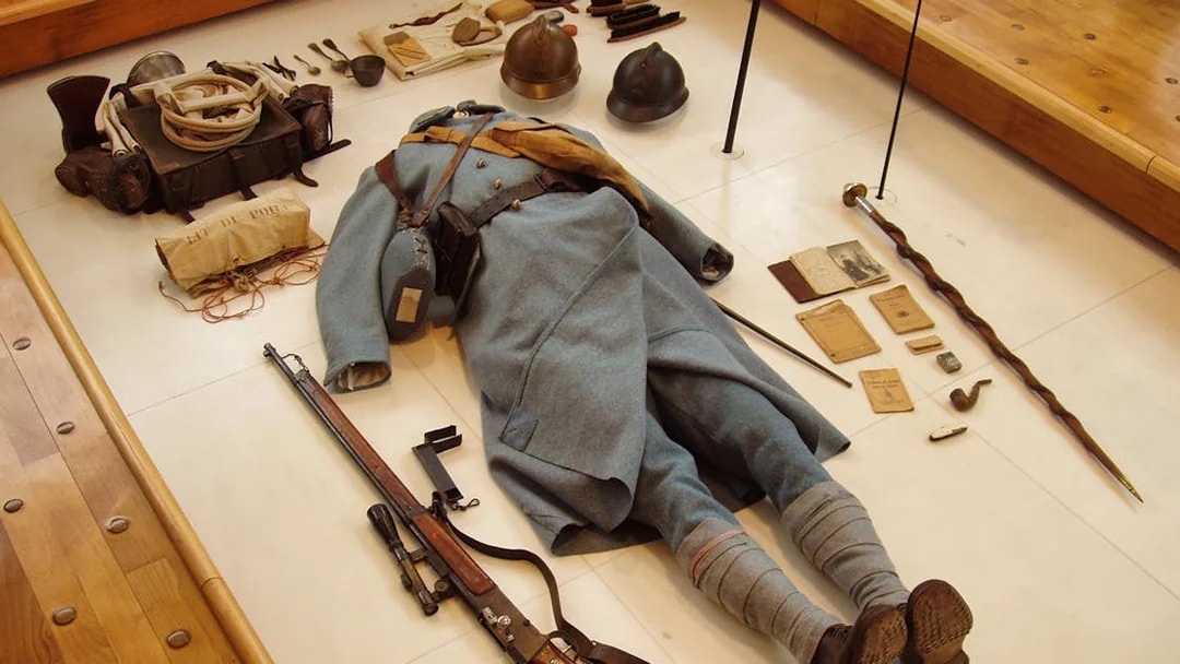 World War II soldier's uniform and equipment display at Normandy museum.