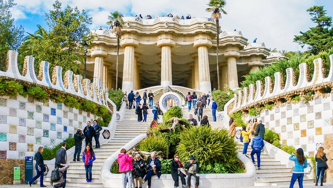 Visitors on the mosaic stairs of Park Güell, Barcelona.