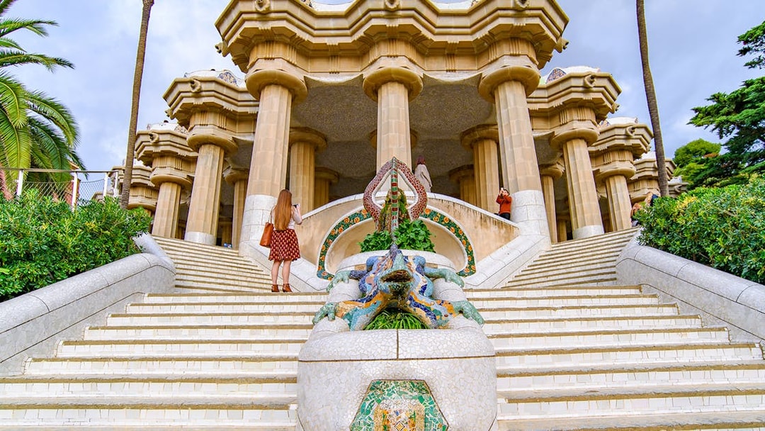 Tourist at the dragon staircase of Park Güell, Barcelona.