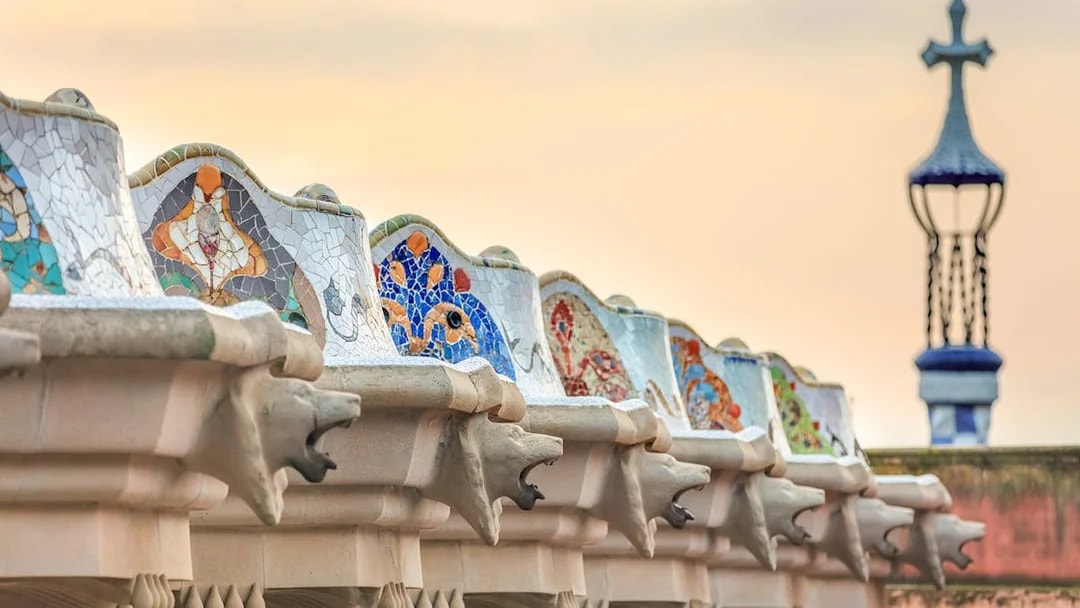 Mosaic benches and sculptures at Park Güell, Barcelona, during a guided tour.