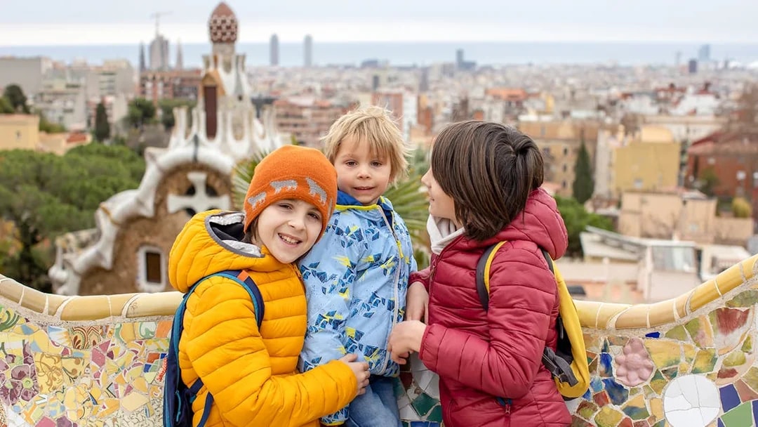 Family enjoying view from Park Güell terrace, Barcelona.