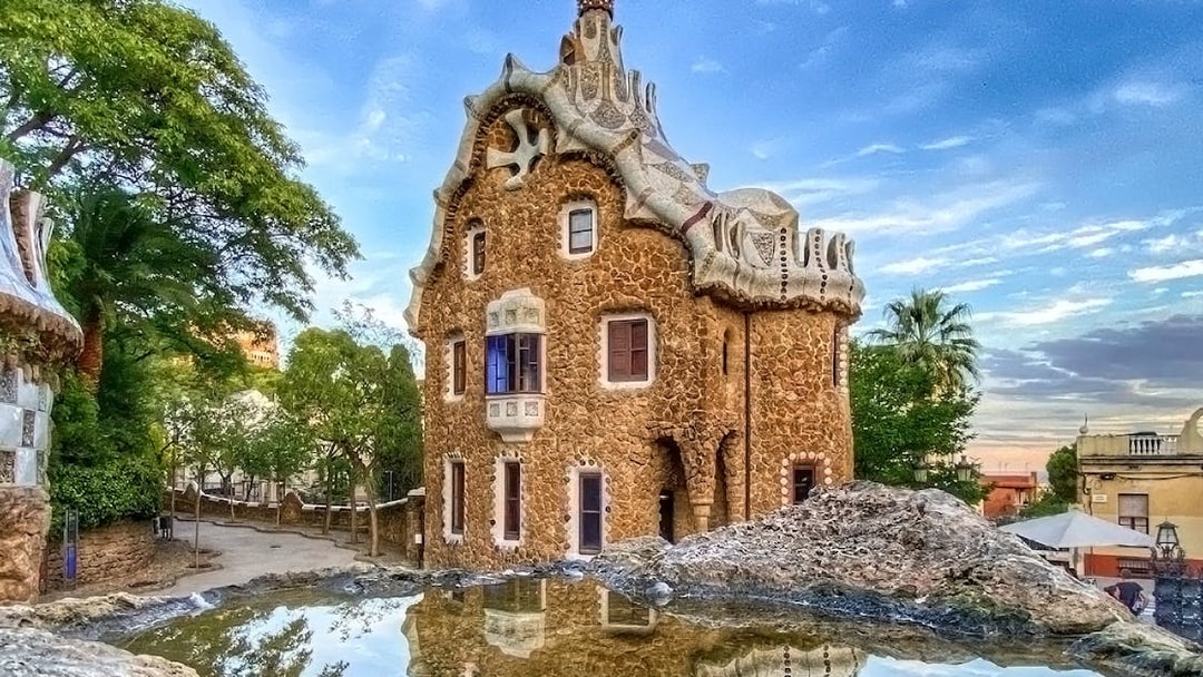 Park Güell's unique stone building with mosaic roof in Barcelona.