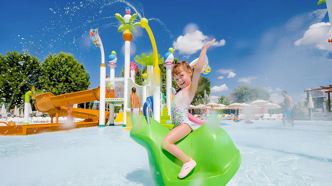 Child enjoying water slide at Parque Warner Beach.
