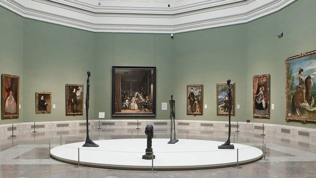 Visitors viewing classic art exhibits at Prado Museum, Madrid, Spain.