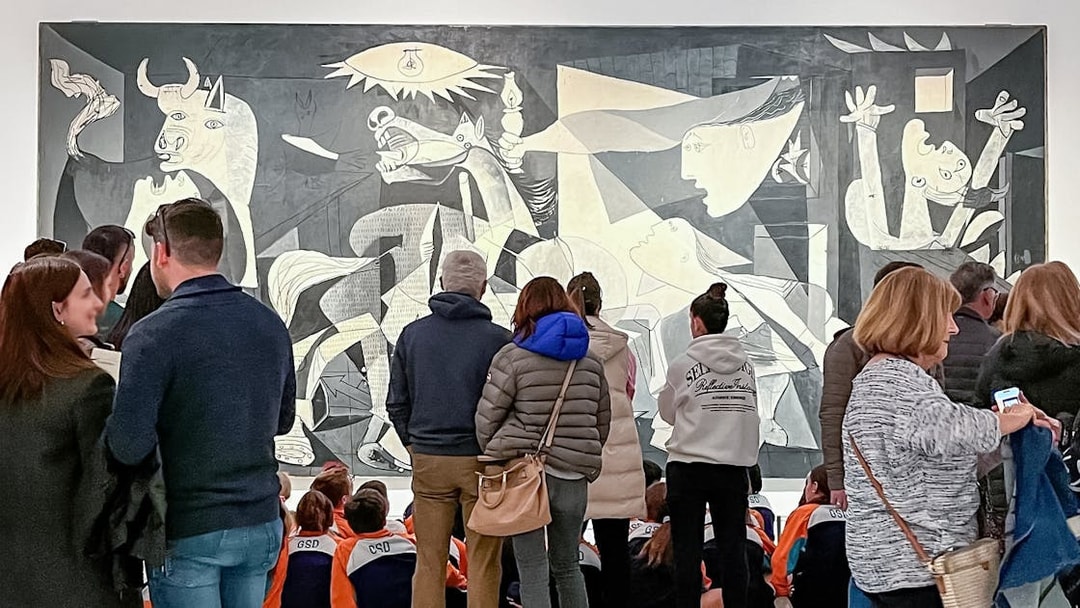 Visitors viewing Picasso's Guernica at Reina Sofia Museum, part of Paseo del Arte 3-Museum Pass.