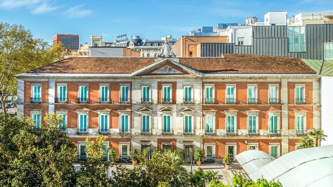 Exterior view of the Thyssen Museum in Madrid with red brick facade.