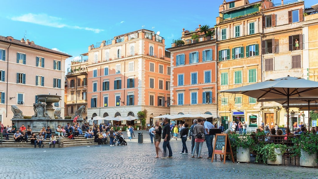 People enjoying the lively atmosphere at Square Santa Maria in Trastevere, Rome, Italy.