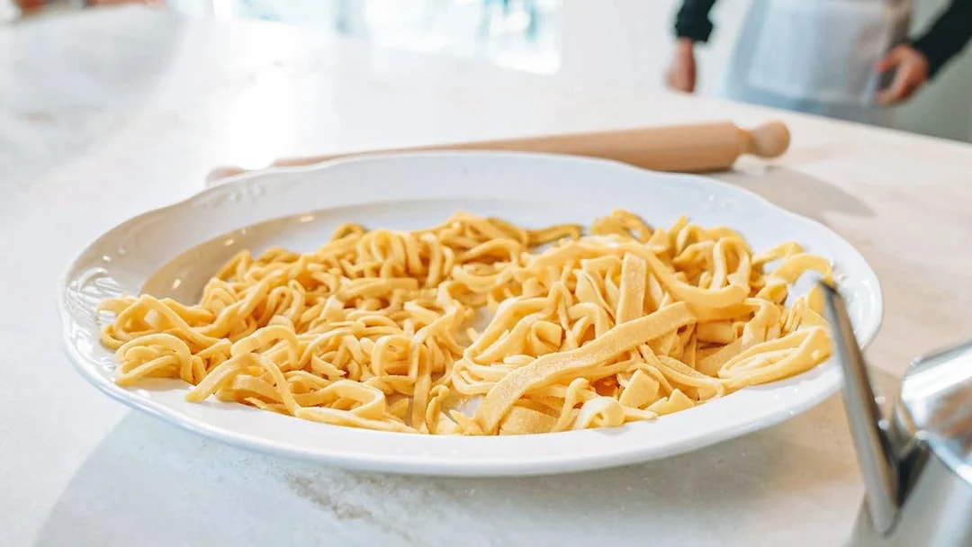 Fresh pasta on a plate during a cooking class.