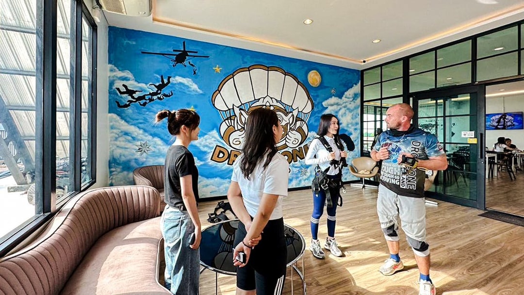 Tourists preparing for Ocean View Tandem Skydive in Pattaya waiting area.