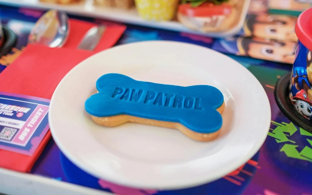 Paw Patrol bone-shaped cookie on Brigit’s Afternoon Tea Bus Tour plate.