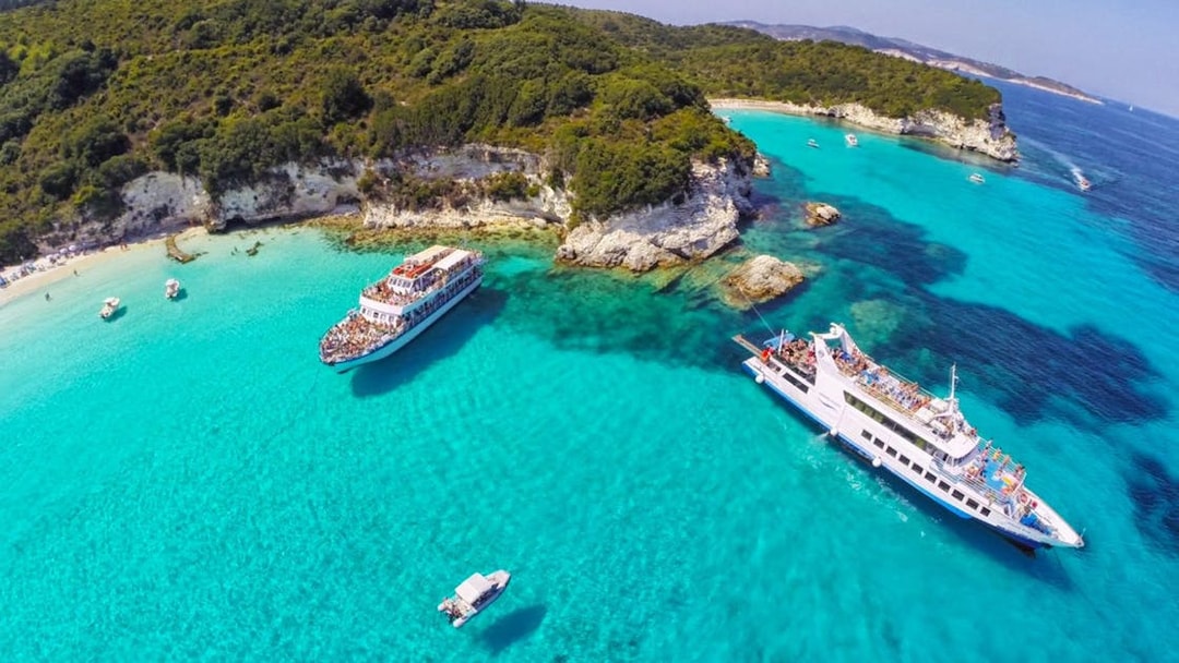Cruise ships near Paxos and Antipaxos islands with turquoise waters and rocky coastline.