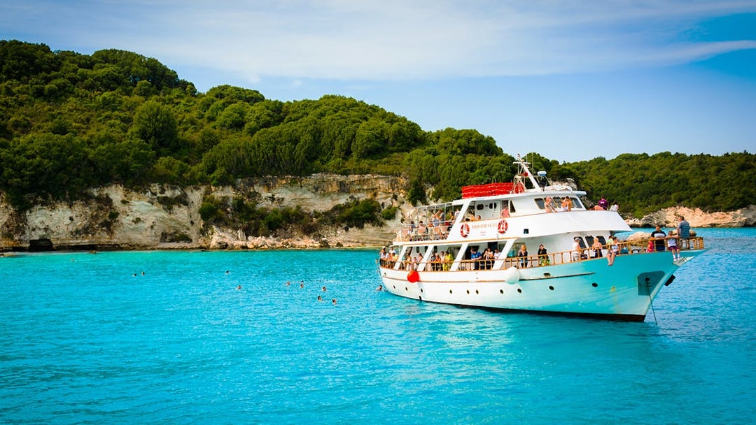 Cruise ship on turquoise waters near Paxos and Antipaxos islands, Greece.