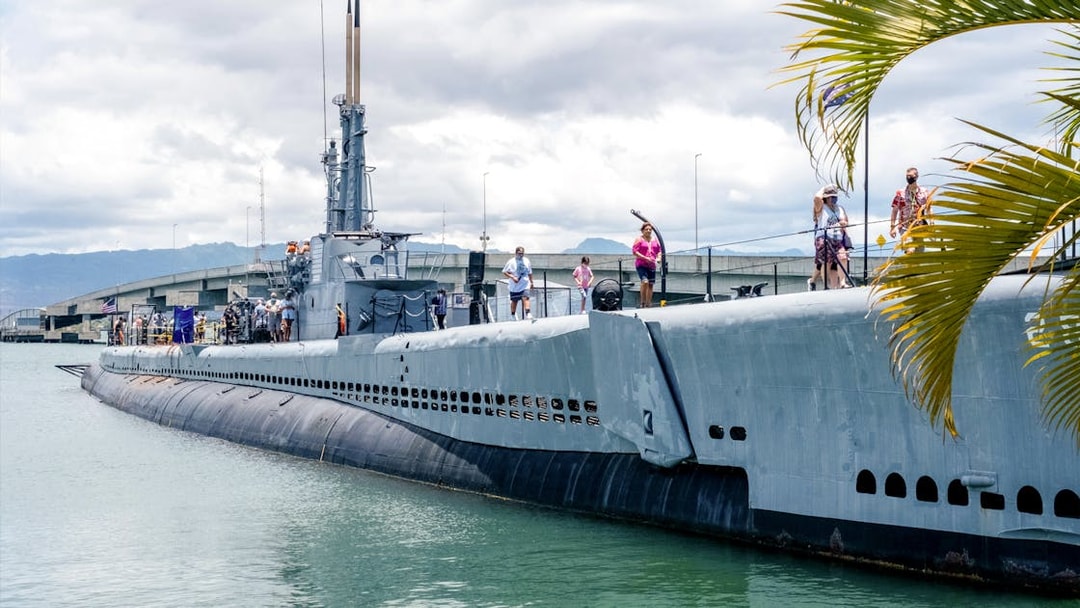 Visitors exploring a Pacific Fleet submarine docked at Pearl Harbor.
