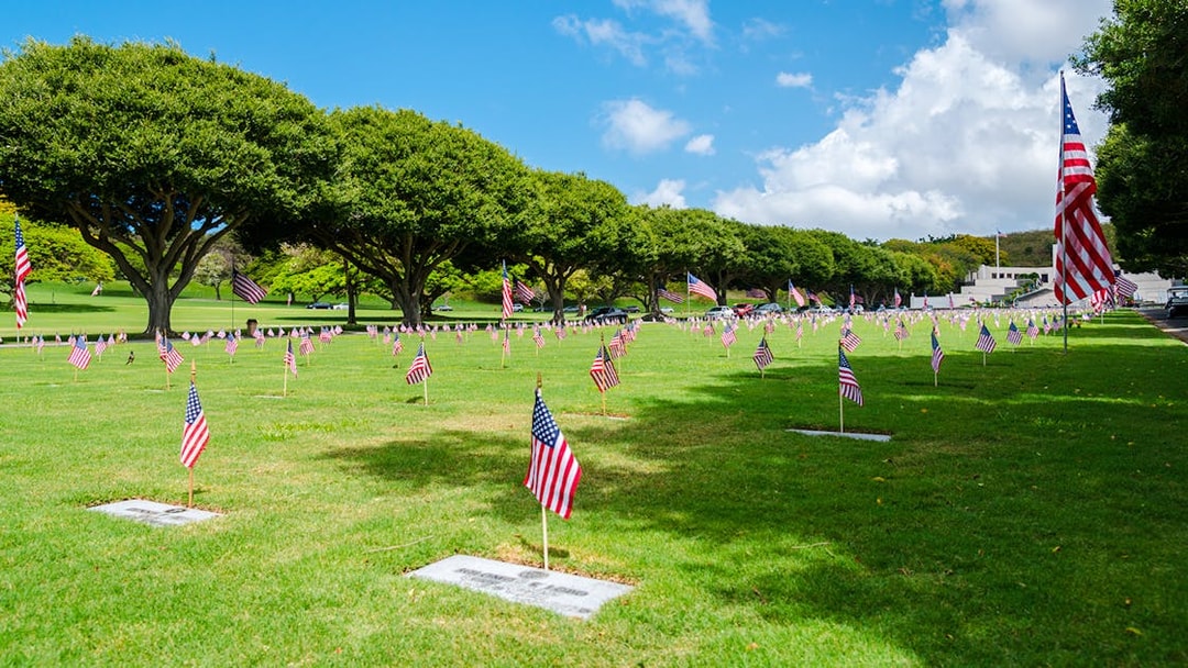 Graves with American flags at Punchbowl National Memorial Cemetery of the Pacific.