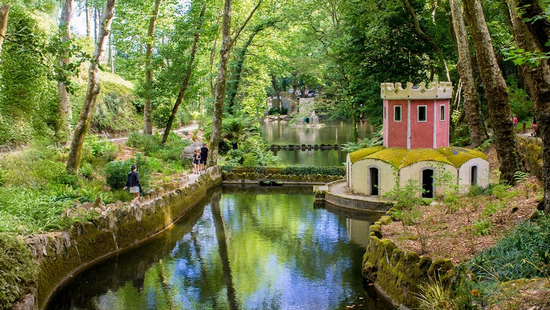 Pond and small tower in the gardens of Pena Palace, Sintra, Portugal.