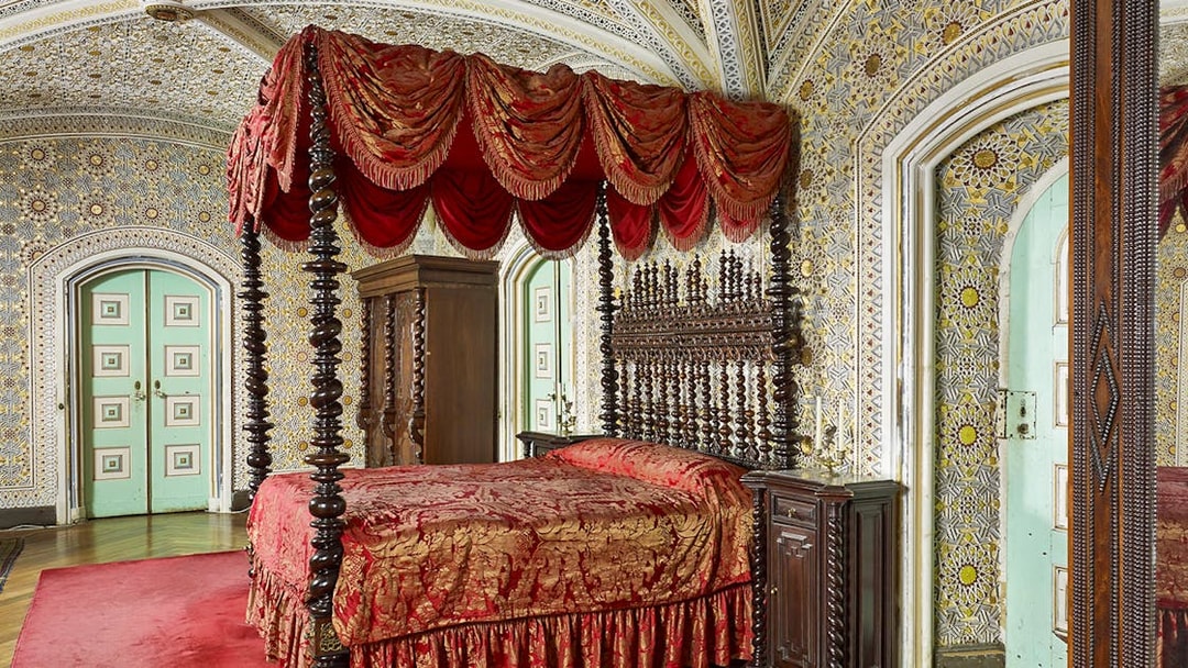 Bedroom of Ferdinand II in Royal Apartments, Pena Palace, featuring ornate bed and intricate wall designs.