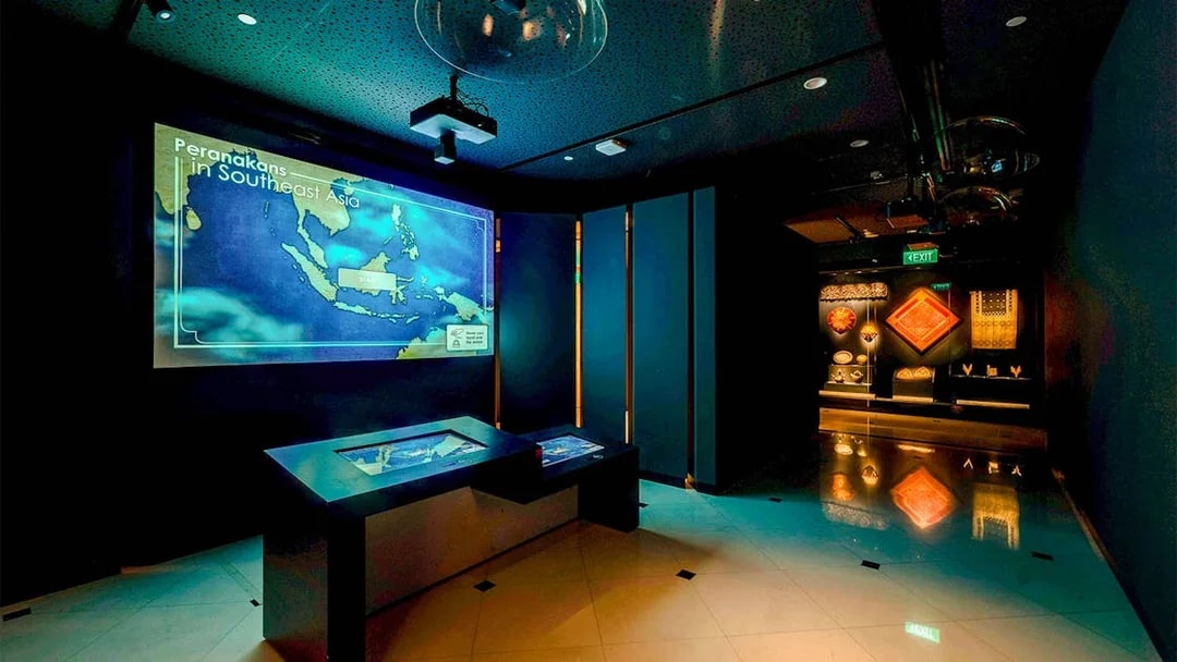 Peranakan Museum gallery with Southeast Asia map display and cultural artifacts.