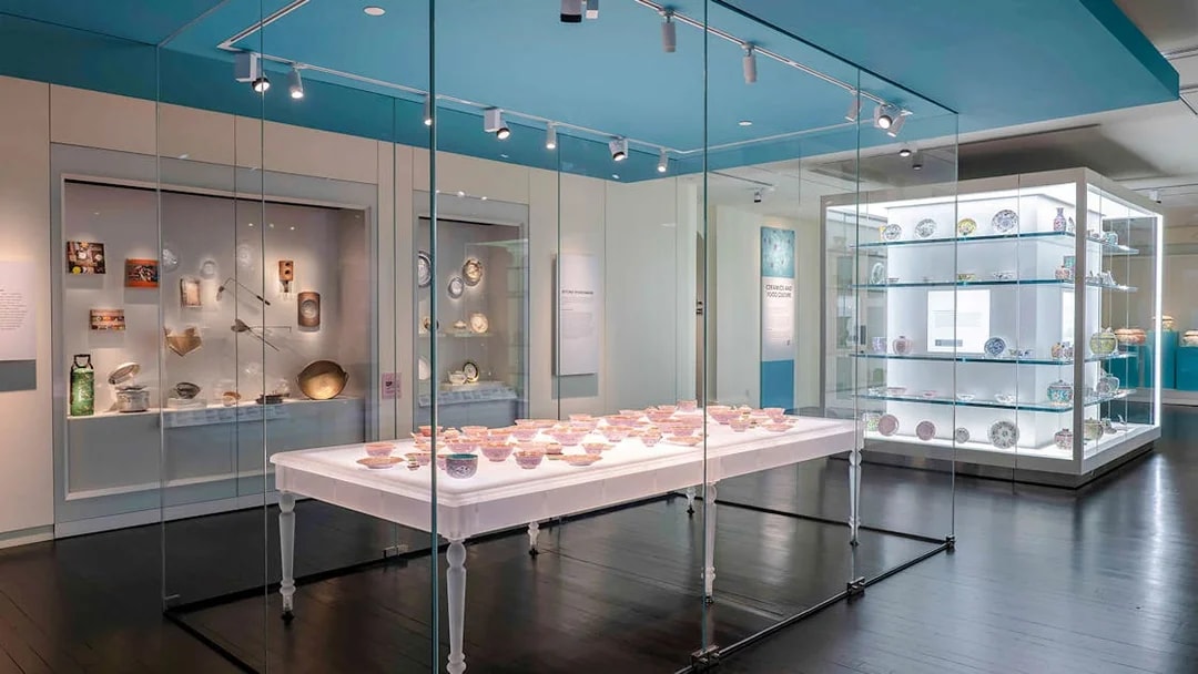 Peranakan Museum gallery displaying traditional ceramics and artifacts in glass cases.