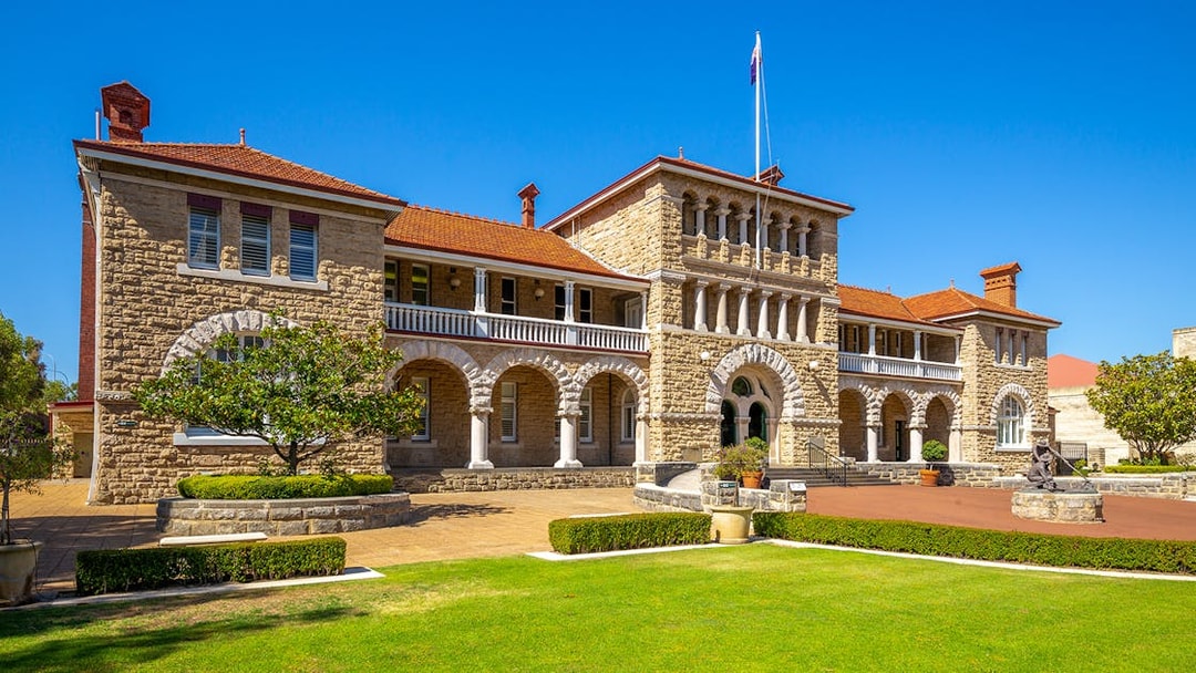 Historic building in Kings Park, Perth, with stone arches and manicured gardens.