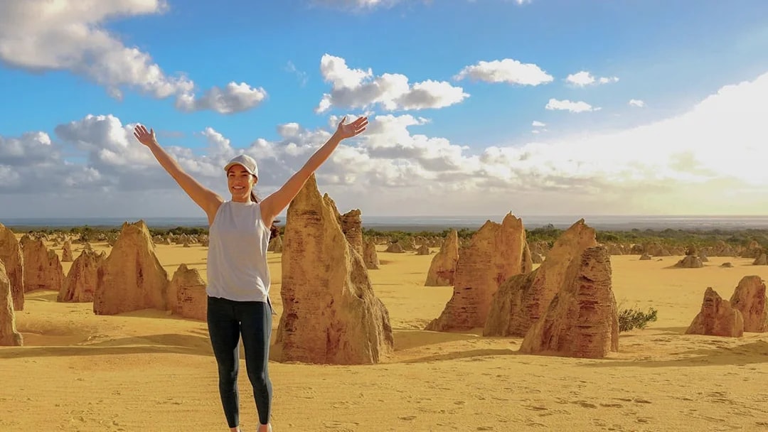 Pinnacles Desert with person enjoying limestone formations on 1-Day Guided Tour from Perth.