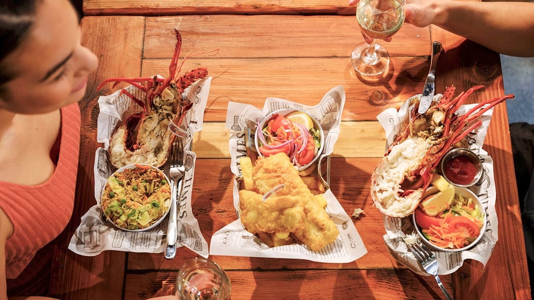 Lobster and fish meal on a wooden table during 1-Day Guided Pinnacles Lobster Lavender Tour from Perth.