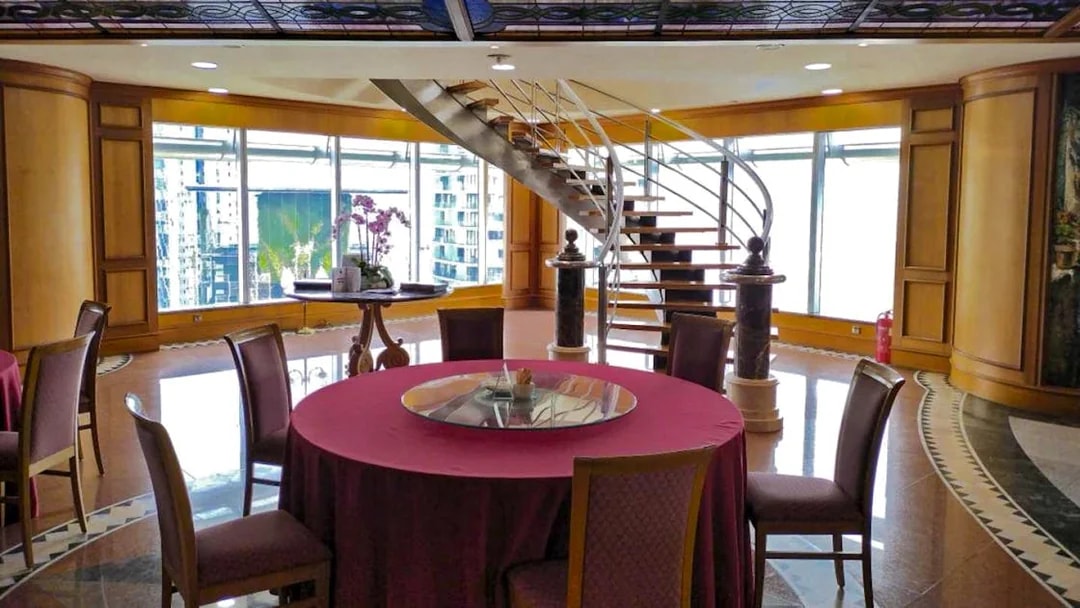 Dining area with round table and spiral staircase, Petronas Twin Towers, Kuala Lumpur.