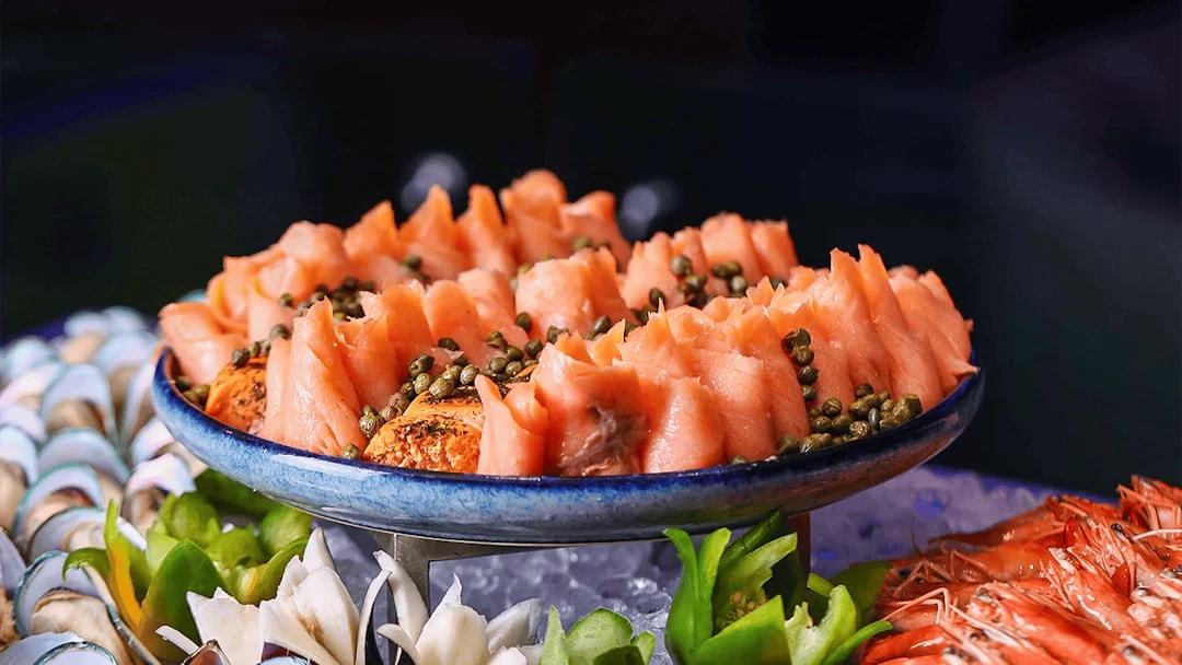 Smoked salmon with capers on a platter, part of Petronas Twin Towers dining experience.