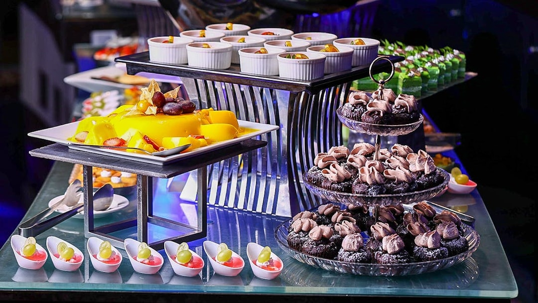 Dessert buffet with pastries and fruit at Petronas Twin Towers dining experience.