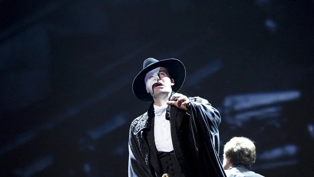 Performer in Phantom of the Opera costume on stage.