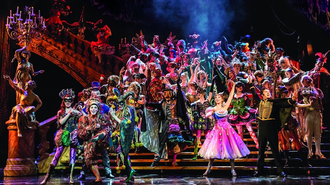Cast performing a vibrant masquerade scene in Phantom of the Opera, West End.