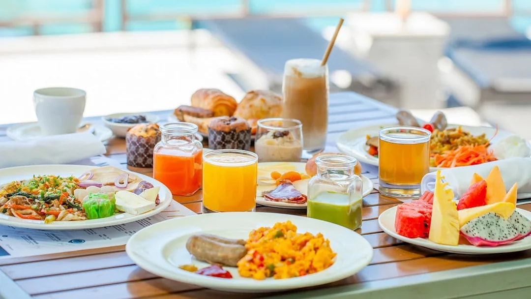 Breakfast spread with fruits, pastries, and juices at Sea Angel pier.