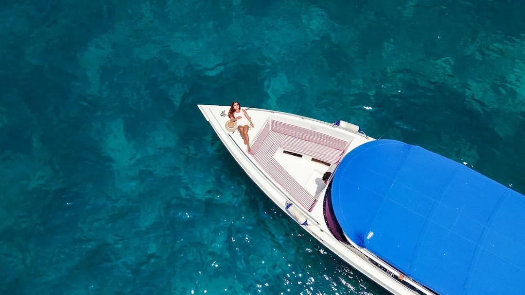 Lady relaxing on a speedboat in Maya Bay, Thailand.
