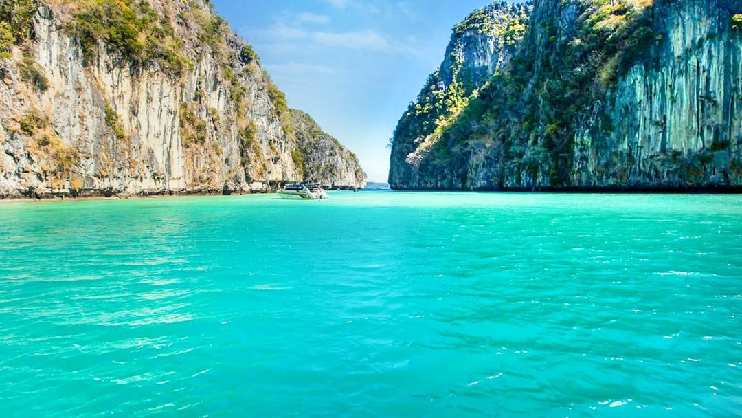 Boat sailing through limestone cliffs towards Maya Bay, Phi Phi Islands.