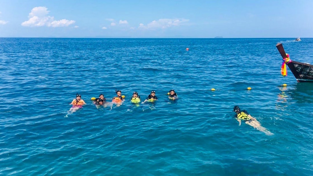 Group snorkeling in clear water near Bamboo Island, Phi Phi tour.