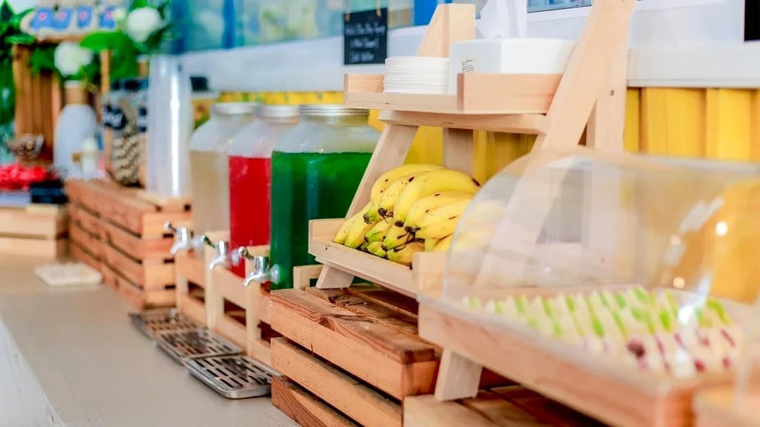 Buffet with bananas, drinks, and assorted food items in Phuket.