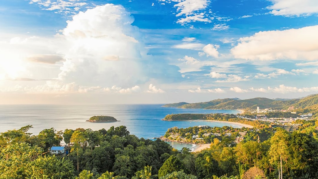 Phuket coastline with lush greenery and ocean view, ideal for ATV and zipline adventure.