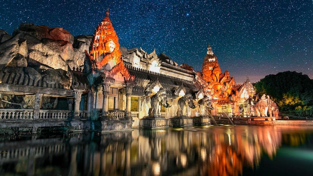 Phuket Fantasea illuminated temple with elephant statues at night, Phuket, Thailand.