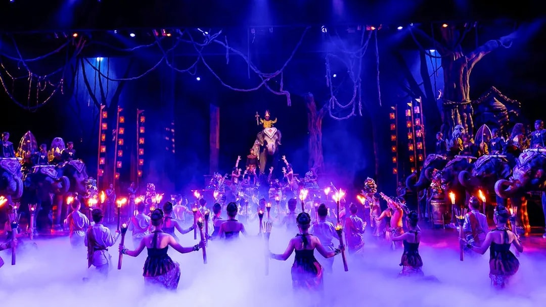 Dancers with torches performing on stage at Phuket Fantasea, Thailand.