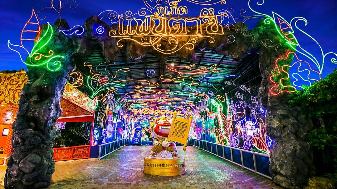 Phuket Fantasea entrance with vibrant neon lights and decorative archway.