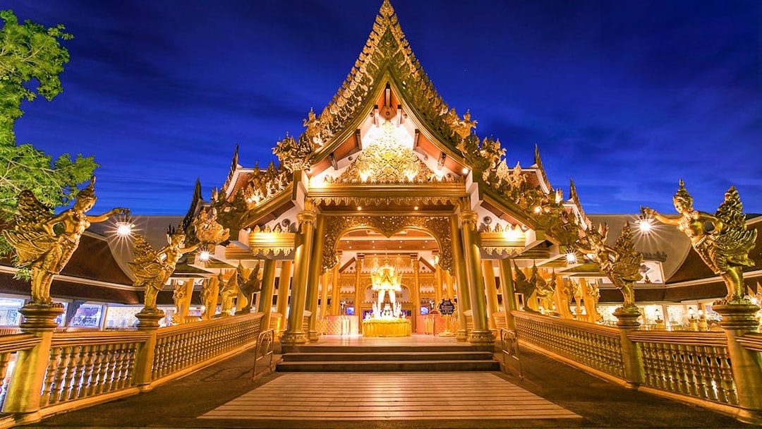 Phuket Fantasea entrance illuminated at night, featuring ornate golden architecture.