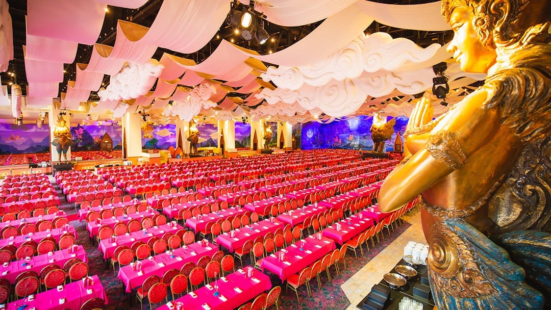 Phuket Fantasea theater with ornate decor and rows of red seats.