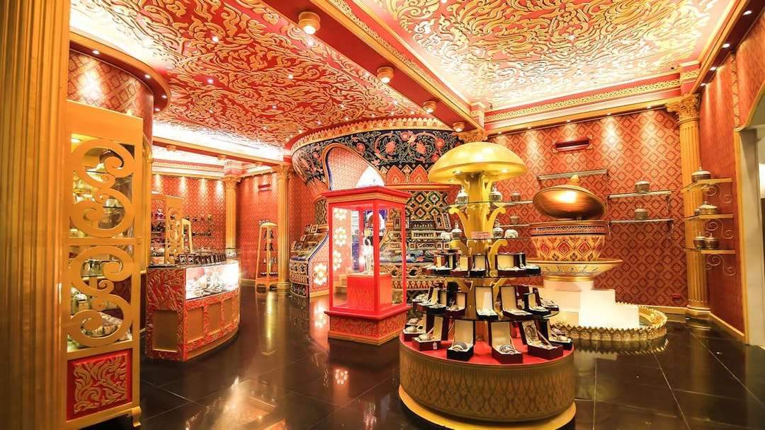 Phuket Fantasea ornate interior with vibrant red and gold decor, showcasing jewelry displays.
