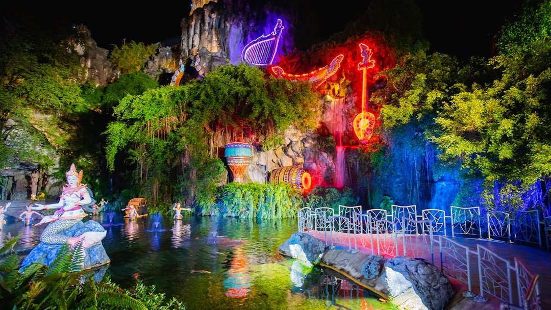 Phuket Fantasea neon-lit sculptures and water feature at night.