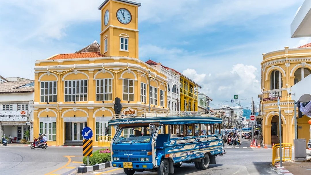 Phuket Old Town with blue local bus and Sino-Portuguese architecture on a guided tour.